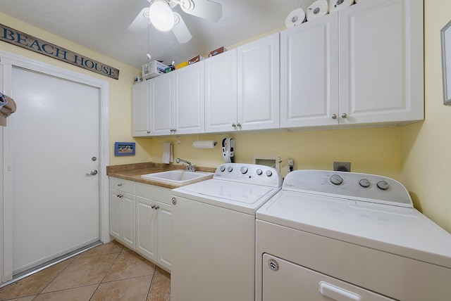 clothes washing area with ceiling fan, sink, cabinets, washer and clothes dryer, and light tile patterned floors