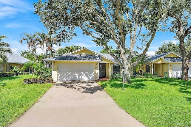 ranch-style house featuring a garage and a front lawn