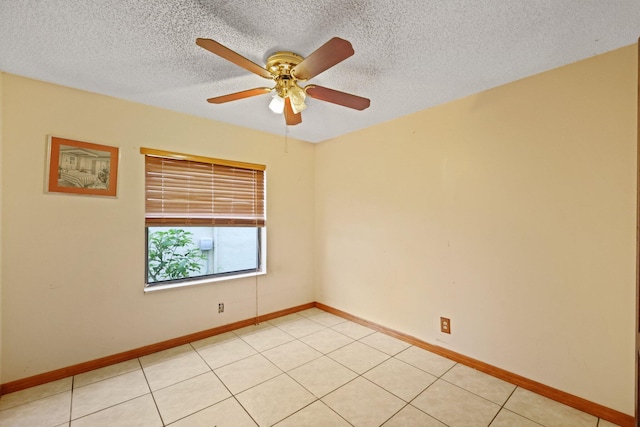 tiled spare room featuring a textured ceiling and ceiling fan