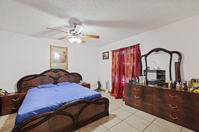 tiled bedroom with a textured ceiling and ceiling fan