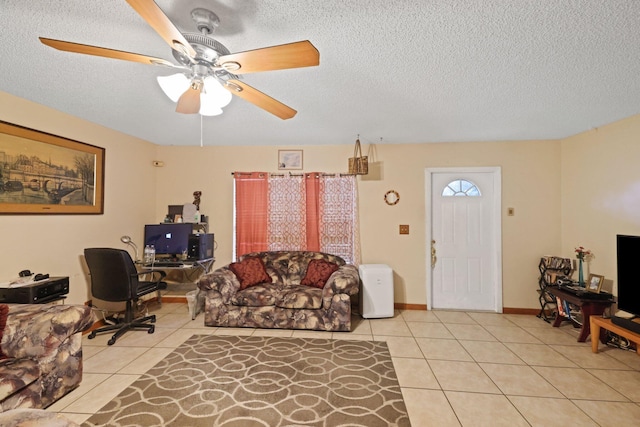 office with a textured ceiling, light tile patterned flooring, and ceiling fan