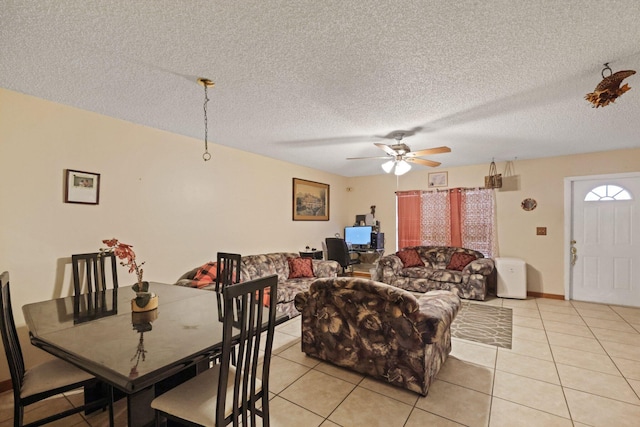 tiled dining room featuring a textured ceiling and ceiling fan