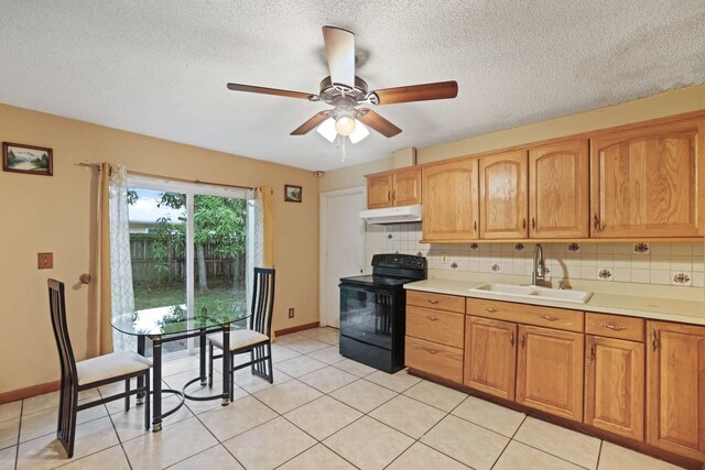 kitchen featuring a textured ceiling, backsplash, sink, ceiling fan, and electric range