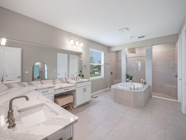 bathroom featuring plus walk in shower, tile patterned floors, and vanity