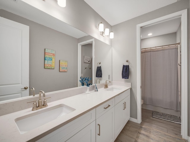 bathroom with vanity and wood-type flooring