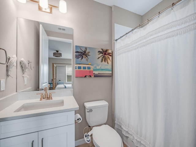 bathroom featuring a shower with shower curtain, toilet, and vanity