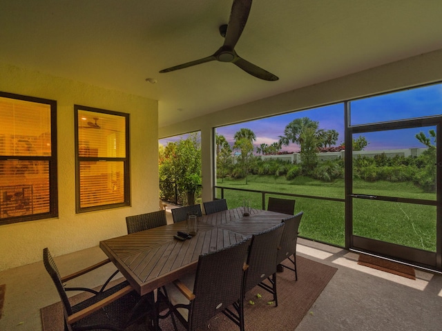 sunroom / solarium featuring ceiling fan