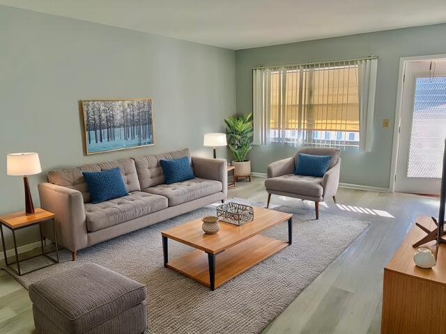 living area featuring baseboards and wood finished floors