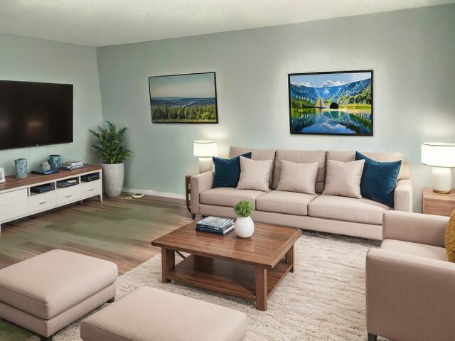 living area with wood finished floors and baseboards