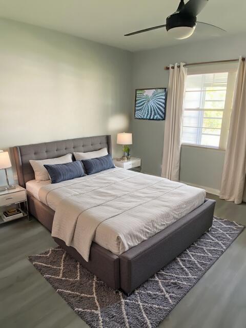 bedroom featuring ceiling fan and hardwood / wood-style flooring