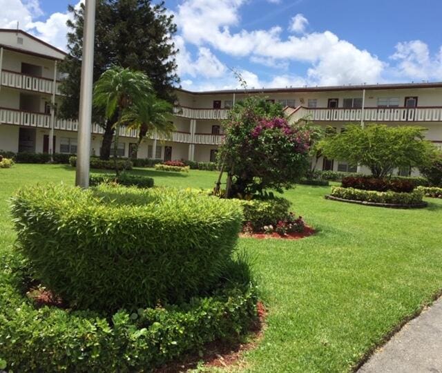 view of home's community with a yard