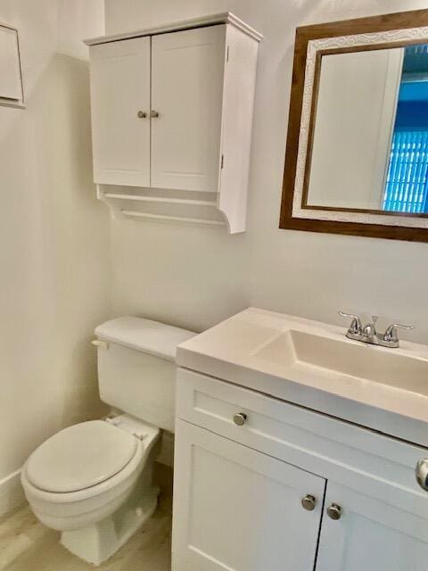 bathroom featuring toilet and vanity