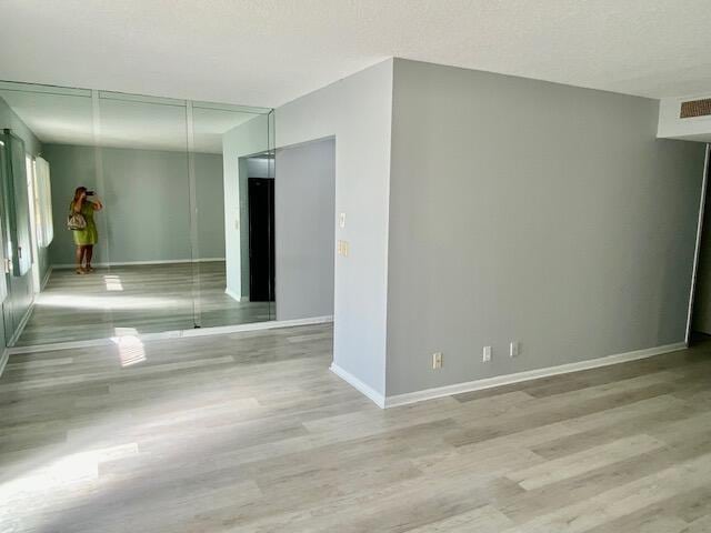 empty room with light hardwood / wood-style floors