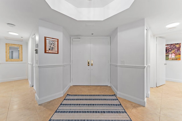 entryway with light tile patterned flooring