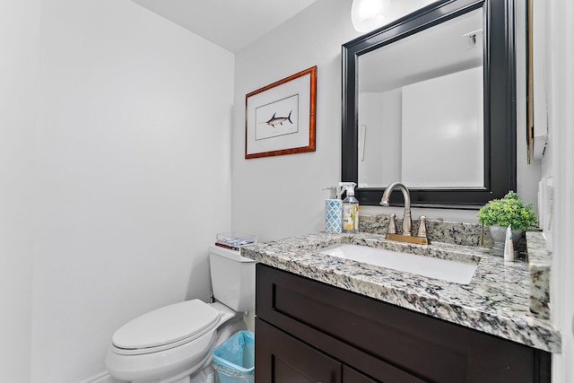 bathroom featuring toilet and vanity