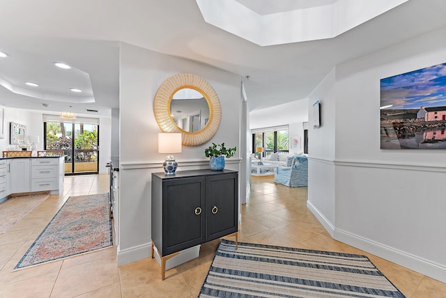 corridor featuring a wealth of natural light and light tile patterned floors