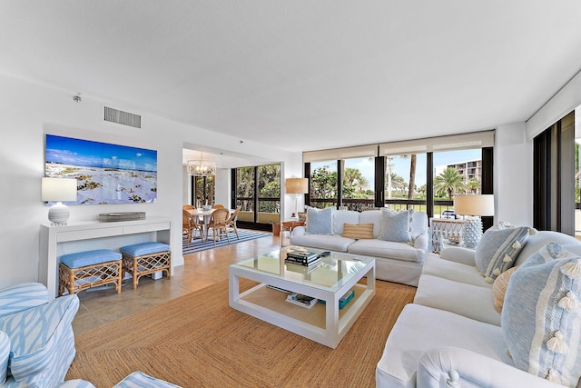 living room with light tile patterned floors, floor to ceiling windows, and an inviting chandelier