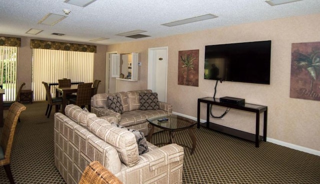 carpeted living room featuring a textured ceiling