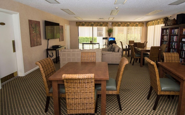 dining space featuring a textured ceiling and carpet floors