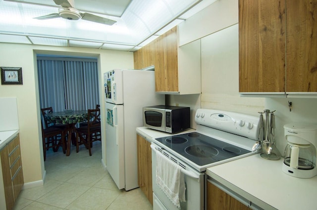 kitchen featuring white appliances, light tile patterned floors, and ceiling fan