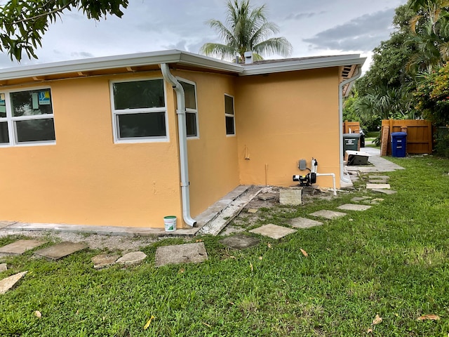 view of side of home featuring a patio area and a yard