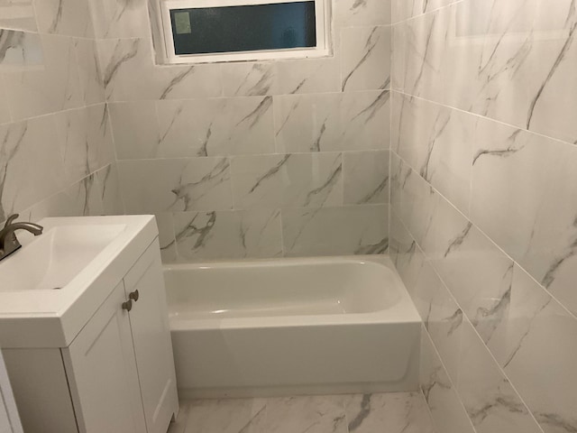 bathroom with tiled shower / bath and vanity