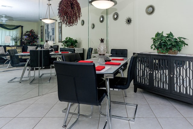 dining space with ceiling fan and light tile patterned floors