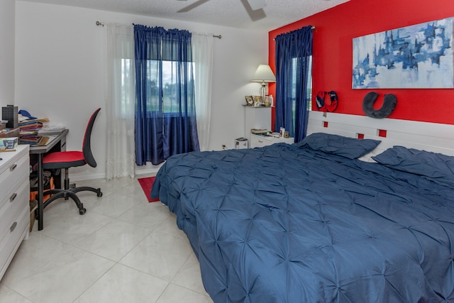 bedroom featuring ceiling fan and a textured ceiling