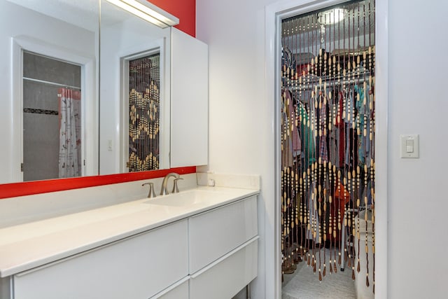 bathroom featuring vanity and curtained shower