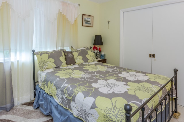 bedroom featuring light carpet and a closet