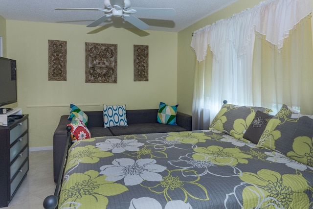 bedroom with ceiling fan and a textured ceiling