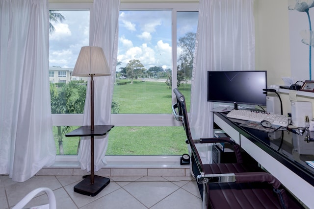 home office with plenty of natural light and light tile patterned floors