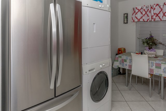 washroom with light tile patterned floors and stacked washer and clothes dryer