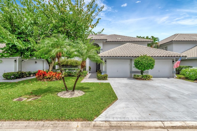 view of front of property with a front yard and a garage