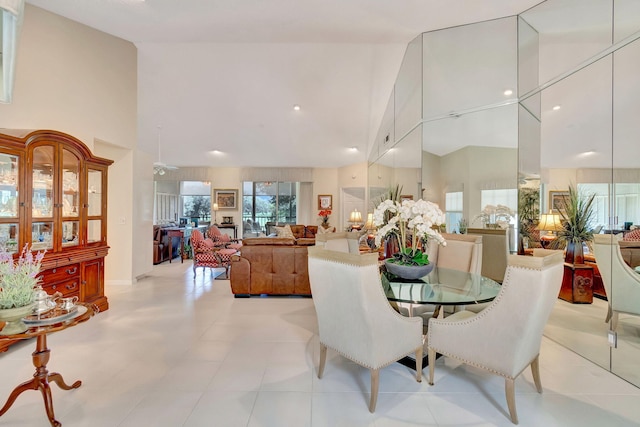 dining room with high vaulted ceiling