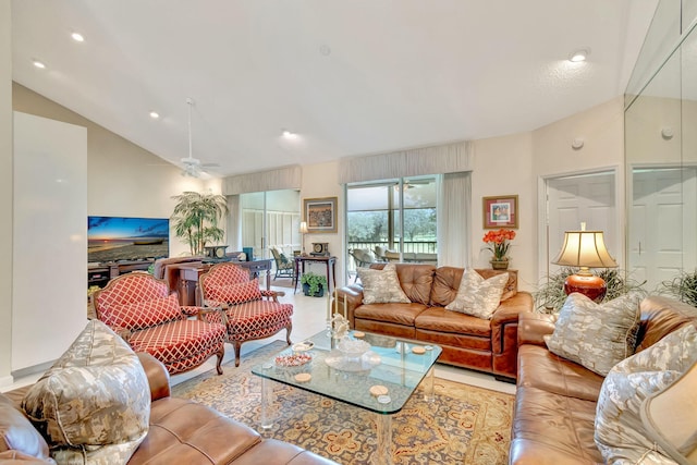 living room featuring vaulted ceiling and ceiling fan