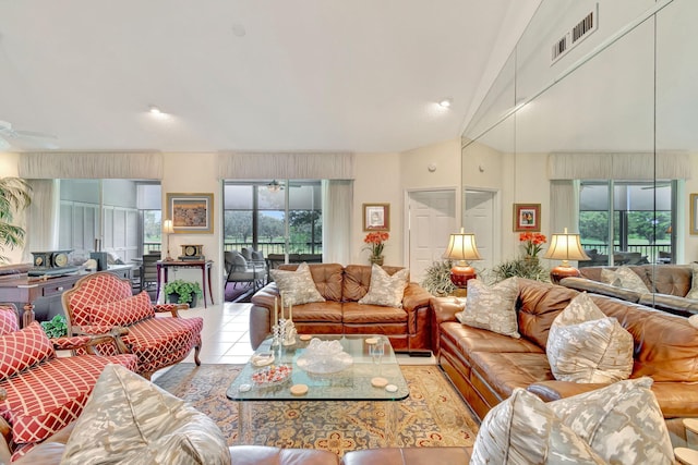 tiled living room featuring a wealth of natural light and ceiling fan