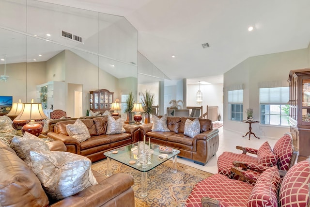 living room with high vaulted ceiling