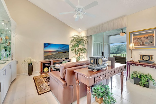 tiled living room featuring a wood stove, high vaulted ceiling, and ceiling fan