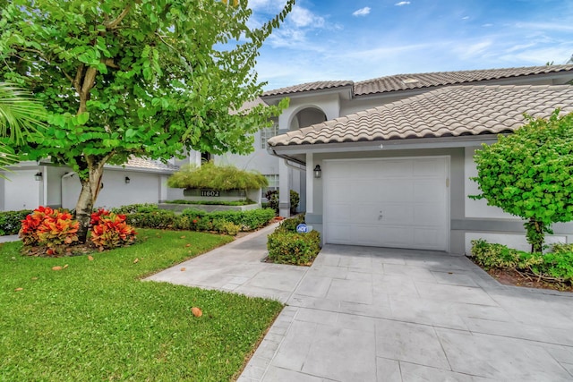 view of front of home with a garage and a front lawn