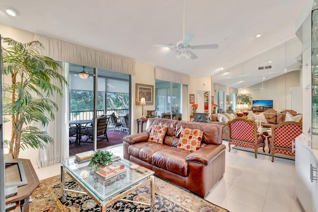 living room with ceiling fan, light tile patterned flooring, and vaulted ceiling