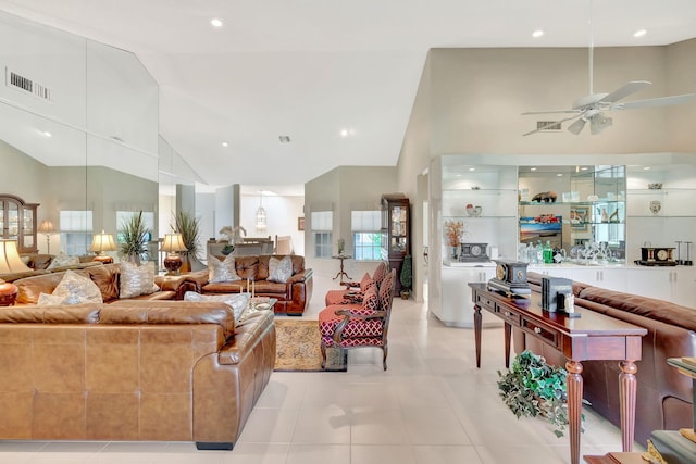 living room featuring ceiling fan, light tile patterned floors, and high vaulted ceiling