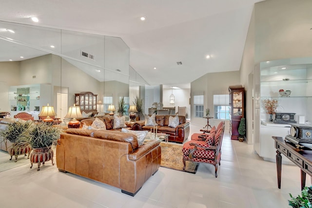 tiled living room with high vaulted ceiling