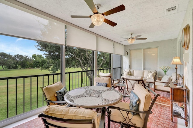 sunroom / solarium with plenty of natural light and ceiling fan