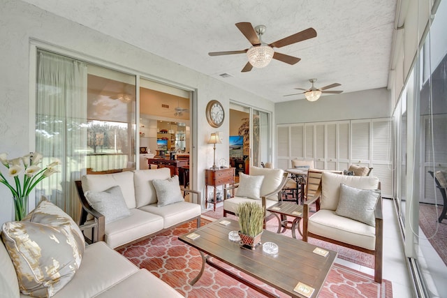 sunroom featuring ceiling fan