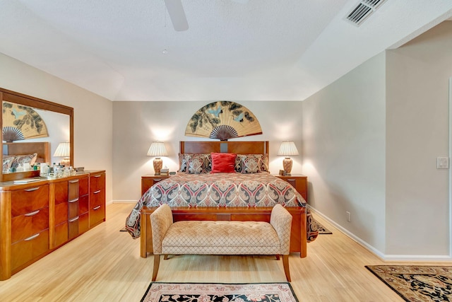 bedroom with ceiling fan and light hardwood / wood-style floors