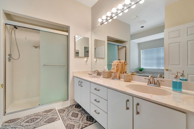 bathroom with vanity, tile patterned floors, and a shower with door