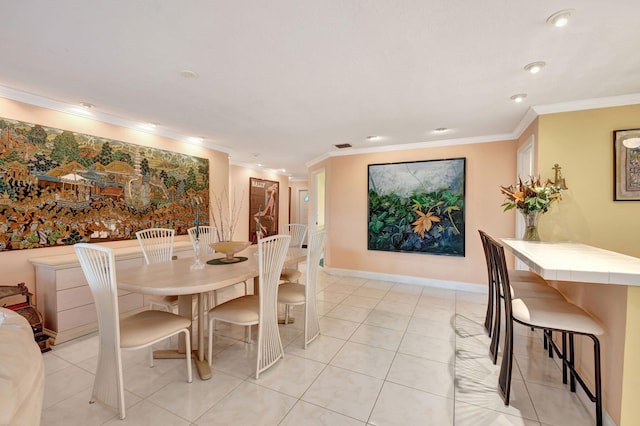 tiled dining area featuring crown molding