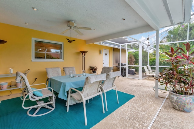 sunroom / solarium featuring beam ceiling and ceiling fan