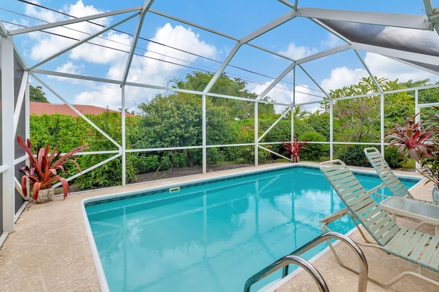 view of swimming pool featuring a lanai